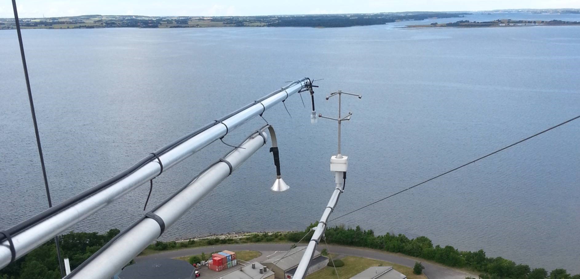 Part of a measuring station with water in the background 